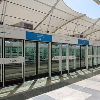 A metro station platform with glass screen doors